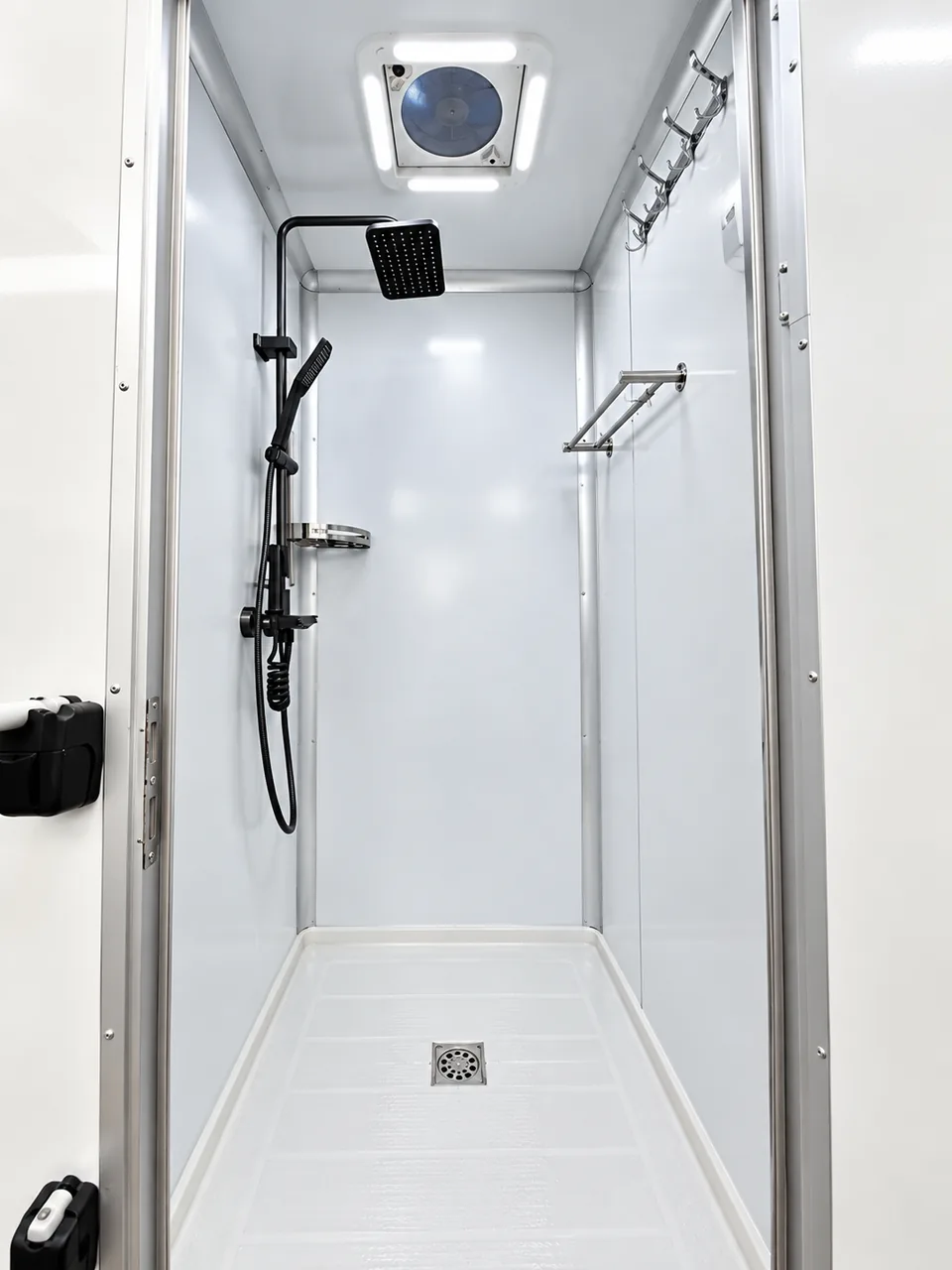 Detailed private shower stall inside a temporary mobile shower trailer